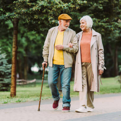 Elderly man and lady walking in the park