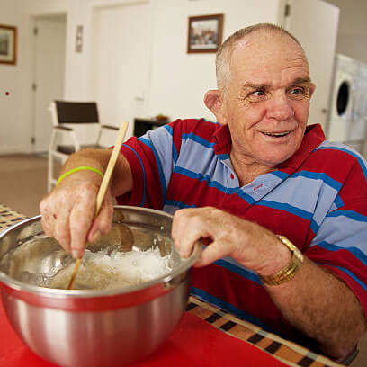 Man stirring bowl of cake mixture